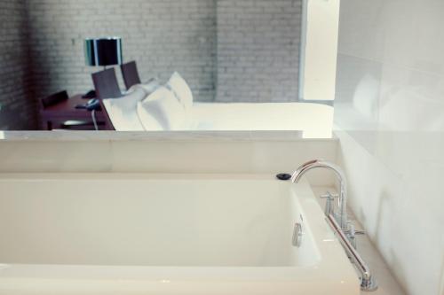 a bathroom with a sink and a mirror at Hotel Ocho in Toronto