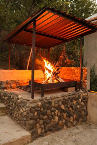 a fire pit with a structure on a stone wall at Guest house Dilijan Orran in Dilijan