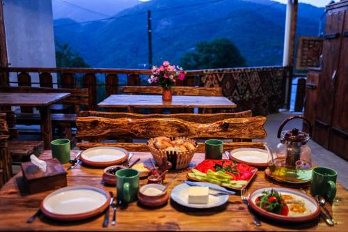 a table with plates of food on top of a balcony at Guest house Dilijan Orran in Dilijan