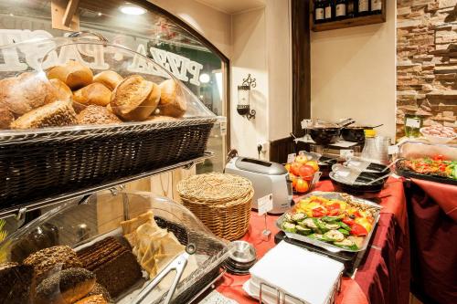 a buffet with bread and vegetables on a table at Boutique 056 Hamburg Central in Hamburg