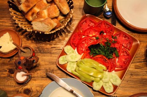a table topped with a tray of vegetables and bread at Guest house Dilijan Orran in Dilijan