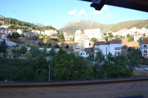 a view of a city with buildings and mountains at Casa da Ponte do Arrocho in Loriga
