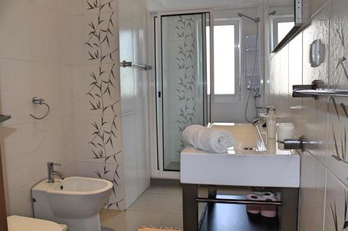 a bathroom with a toilet and a sink and a shower at OurMadeira - ArcoView in Calheta