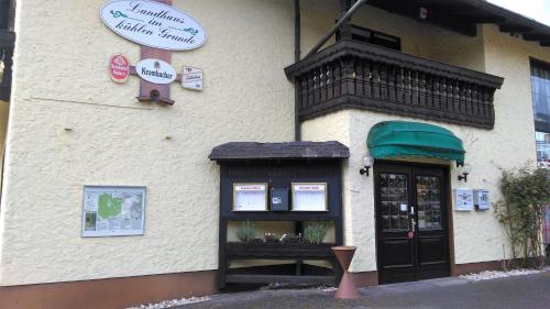 a building with a sign on the side of it at Landhaus im kühlen Grunde Garni in Pracht