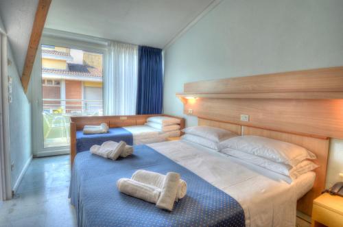 Postel nebo postele na pokoji v ubytování Hotel Mimosa