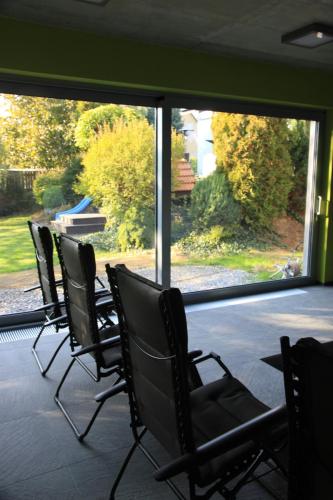 a group of chairs sitting in front of a window at Blue House Relax in Velké Popovice