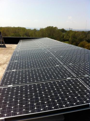 an array of solar panels on the roof of a building at Hotel Viking in Rimini