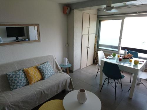 a living room with a couch and a table at Portvendres Sea view in Port-Vendres