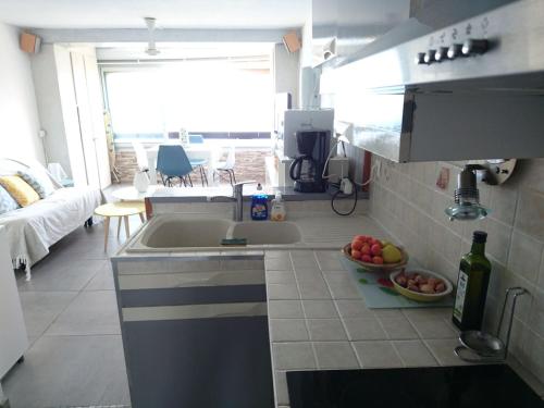 a kitchen with a sink and a bowl of fruit at Portvendres Sea view in Port-Vendres
