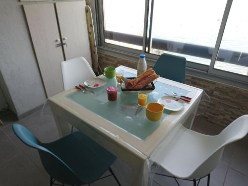 a white table with a plate of food on it at Portvendres Sea view in Port-Vendres