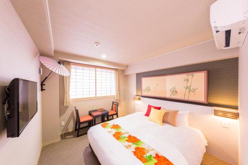 a bedroom with a large bed and a large window at Kyoto Inn Gion The Second in Kyoto