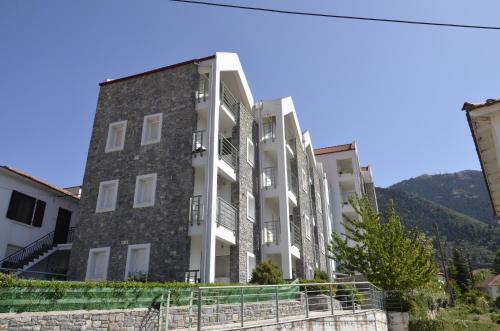 an apartment building with a mountain in the background at Kalavrita Luxurious Apartments in Kalavrita