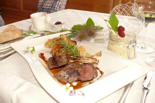 a white plate of food on a table at Gasthof-Pension zur Klause in Ratten