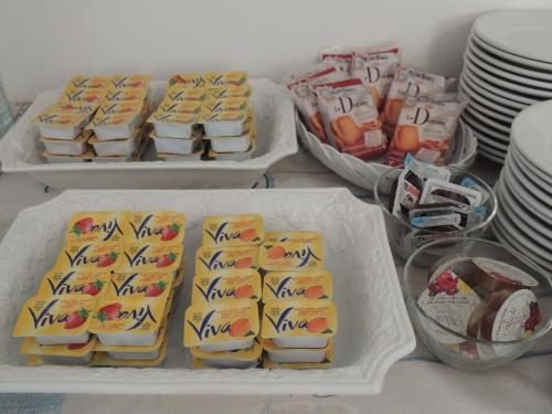 a refrigerator filled with sandwiches and other food items at Hotel ai Fiori in Grado