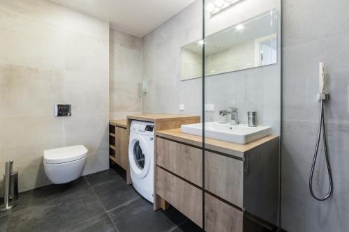 a bathroom with a sink and a washing machine at Tallinn Premium Apartments in Tallinn