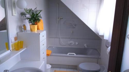 a bathroom with a tub and a toilet and a sink at Haus Ruf in Windischgarsten