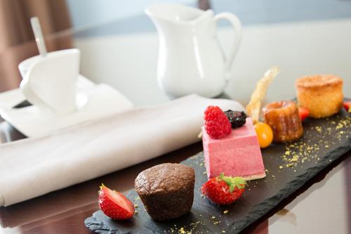 a plate of desserts on a table with strawberries at Alliance Lille - Couvent Des Minimes in Lille