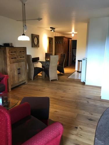 a living room with chairs and a dining room at Landhaus Kössel in Füssen