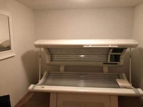 an empty refrigerator in a corner of a room at Landhaus Kössel in Füssen