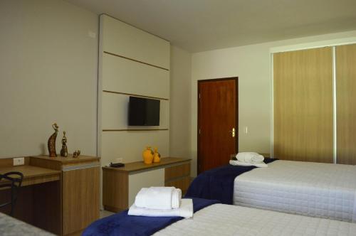 Postel nebo postele na pokoji v ubytování Flat Hotel Vale das Montanhas