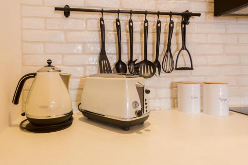 a kitchen counter with a toaster and utensils at Villa Myrto in Líndos