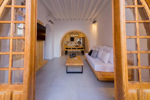 a living room with a white couch and a table at Villa Myrto in Líndos