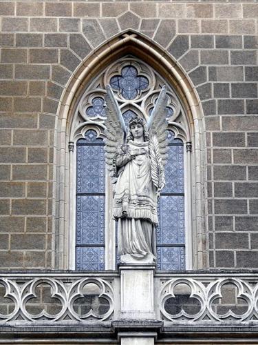 a statue of an angel on the side of a building at Penzion a wellness U Třeboňské madony in Třeboň