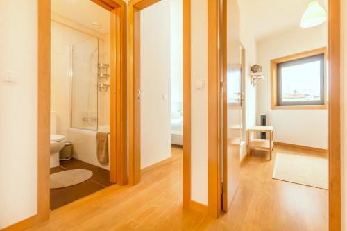 a bathroom with a shower and a toilet in a room at Camões Executive Flat in Porto