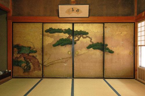a room with a door with a painting on the wall at 高野山 宿坊 不動院 -Koyasan Shukubo Fudoin- in Koyasan