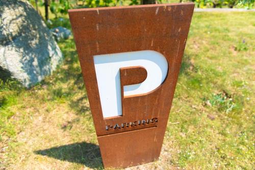 a large wooden parking sign in the grass at Villa Maria in Tremosine Sul Garda