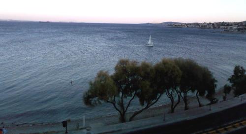 a boat in the water with a sailboat at FAFALIOS Studios in Vrontados