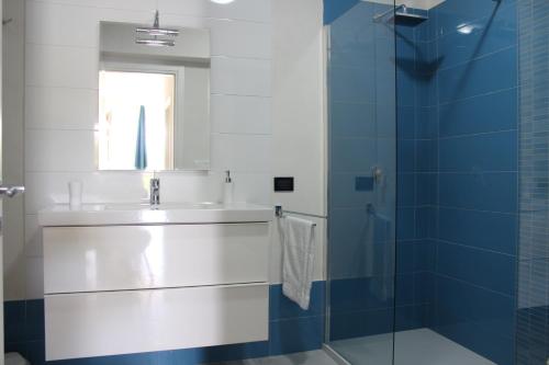 a bathroom with a sink and a glass shower at Isola del sole, Appartamenti con piscina in Balestrate