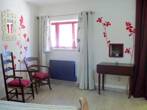 a room with a table and chairs and a desk at Chambres d'Hôtes du Clos Semper Felix in Sainte-Bazeille