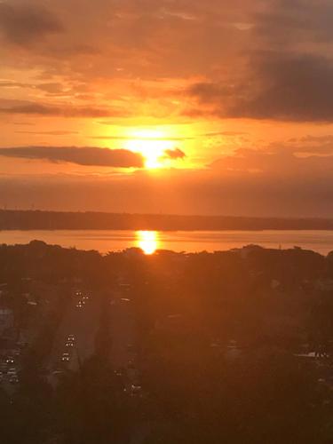 a sunset over the water with the sun in the sky at Quinta del Encanto in Cruz de Huanacaxtle