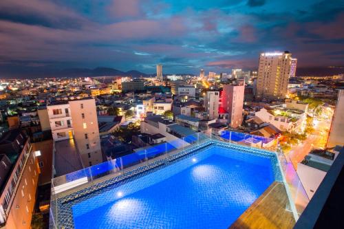 a swimming pool on top of a building at night at Central Hotel & Spa Danang in Da Nang