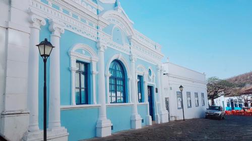 a blue and white building with a street light at Pousada Portalcion in Goiás