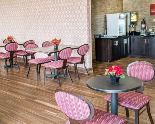 a dining room with tables and pink chairs at Comfort Inn & Suites San Marcos near Outlet Mall in San Marcos