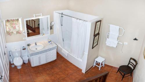 a white bathroom with a sink and a shower at Malpais Trece in Garachico