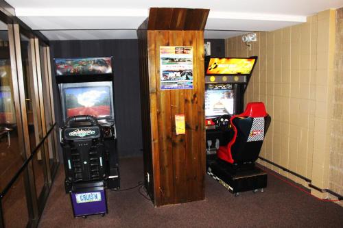 a room with two video game machines and a arcade at Ramada by Wyndham Alpena in Alpena