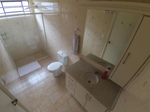 a bathroom with a sink and a toilet and a shower at Jardim Botânico House in Curitiba