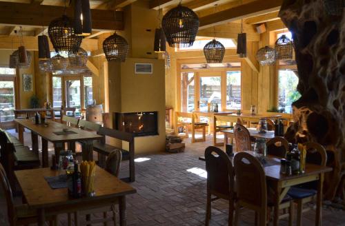 a restaurant with tables and chairs and a fireplace at Počitniška hiša Lazar in Kobarid