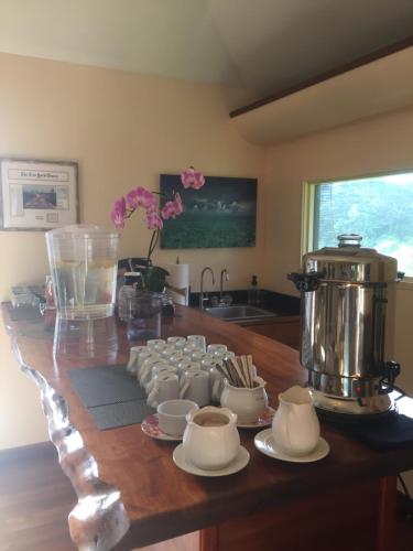 a kitchen counter with a coffee maker on a table at The Inn at Kulaniapia Falls in Hilo