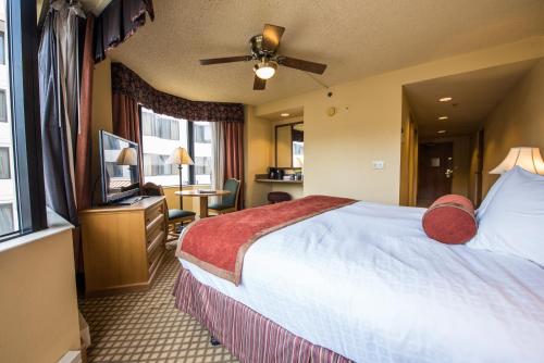 a hotel room with a bed and a television at The Grand Lodge Hotel and Suites in Mount Crested Butte