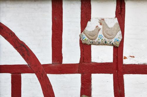 a red and white door with a shoe on it at Rosenlund Bed & Breakfast in Skovsgårde