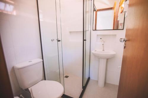 a bathroom with a toilet and a sink at CLH Suites Ilha Grande in Abraão