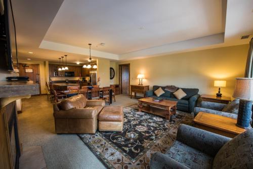 a living room with couches and a dining room at The Lodge at Mountaineer Square in Mount Crested Butte