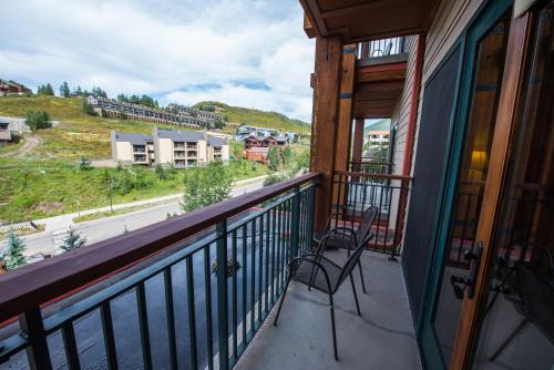 a balcony with two chairs and a view of a street at The Lodge at Mountaineer Square in Mount Crested Butte
