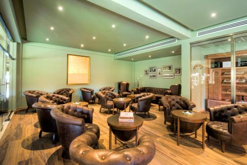 a waiting room with leather chairs and tables at Iberostar Waves Tucan - All Inclusive in Playa del Carmen