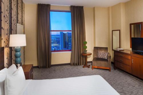 a hotel room with a bed and a large window at Hyatt Regency Buffalo in Buffalo