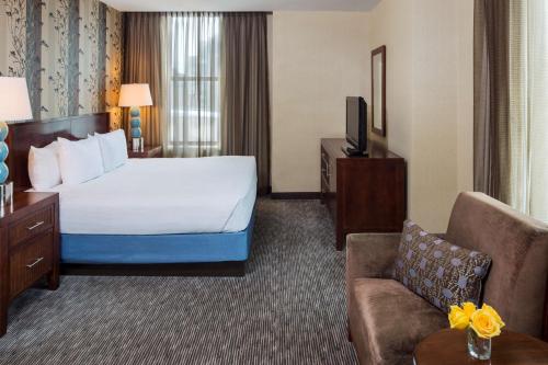 a hotel room with two beds and a chair at Hyatt Regency Buffalo in Buffalo